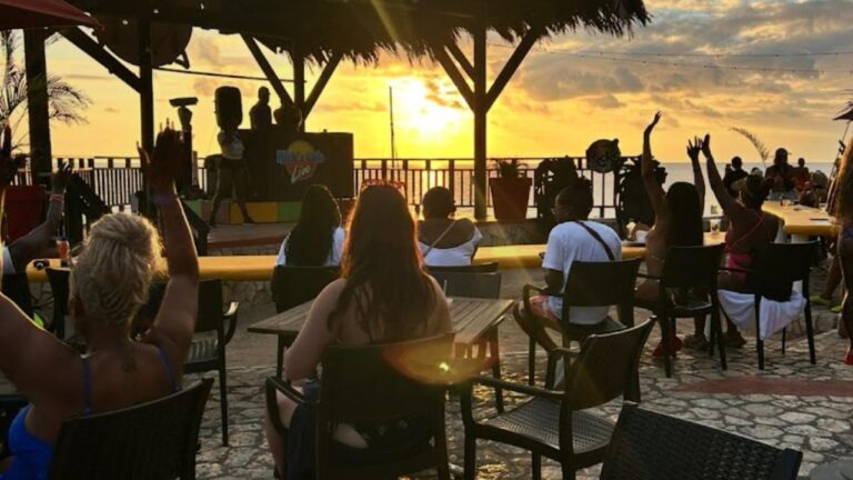Visitors enjoying sunset view at Rick's Cafe Negril