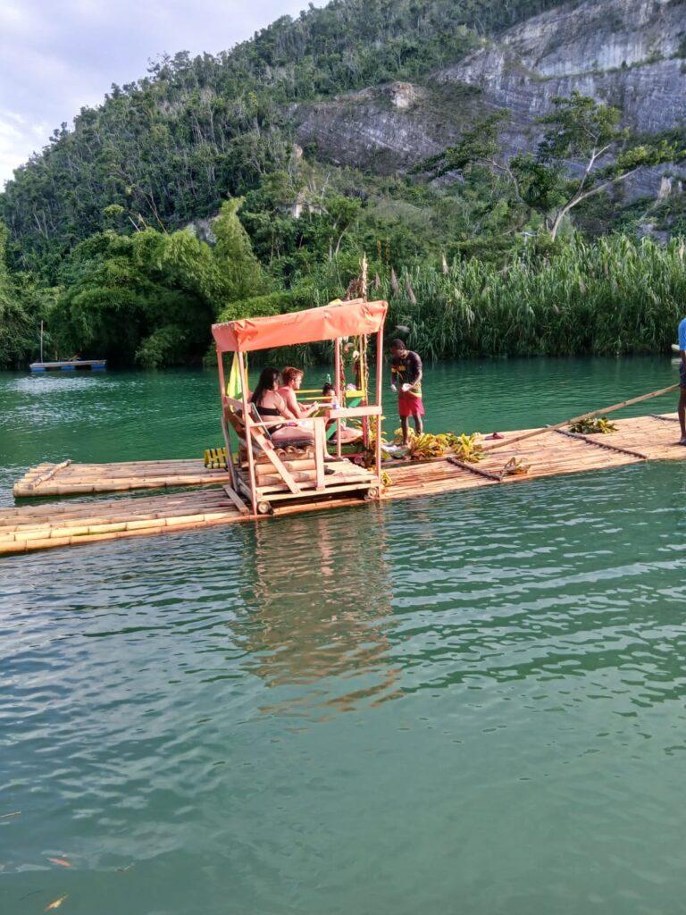 Experienced raft captain guiding a bamboo raft in Lethe, St. James, Jamaica.