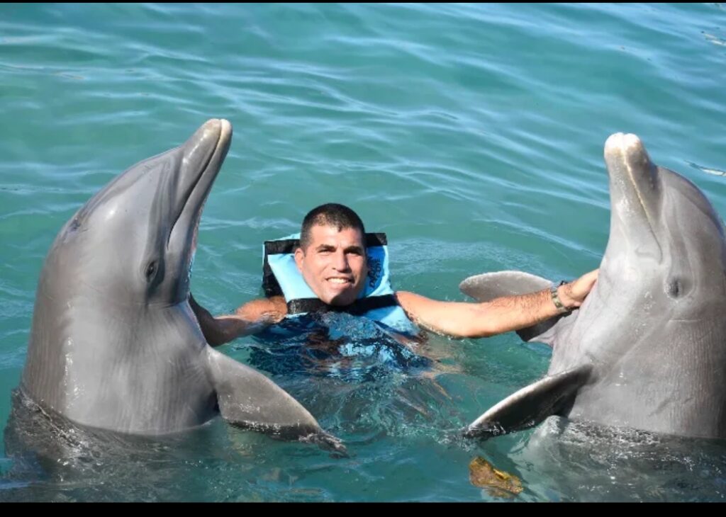Guest enjoying a swim with dolphin at Dolphin Cove Montego Bay